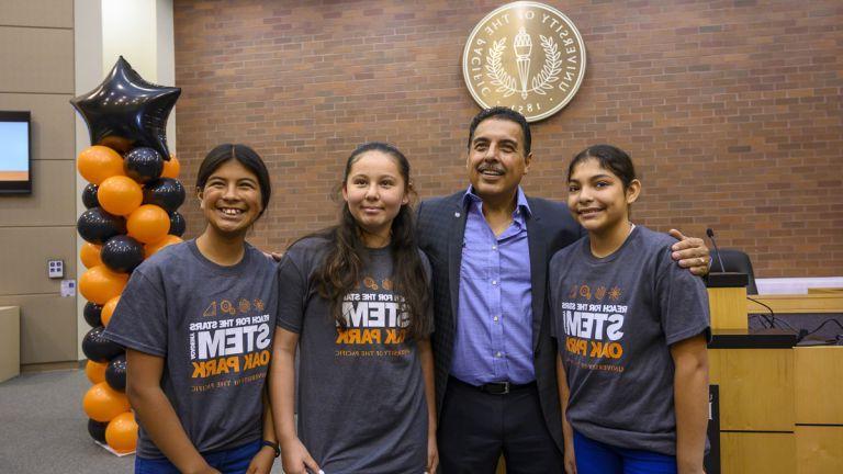 Jose Hernandez standing with students