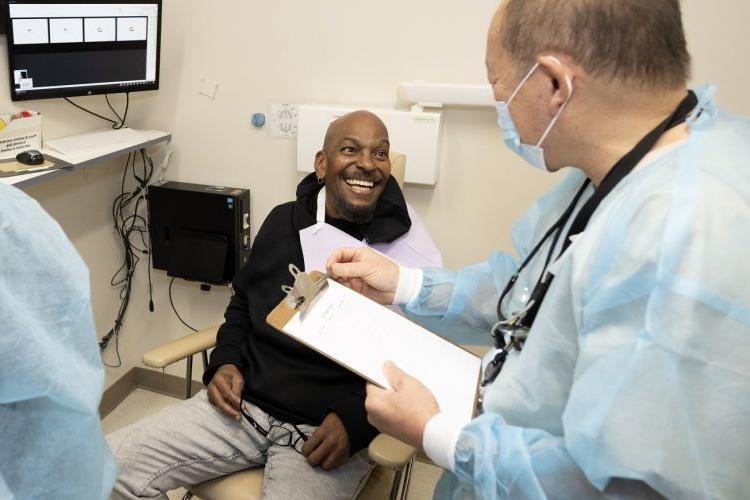 patient sits in dental chair