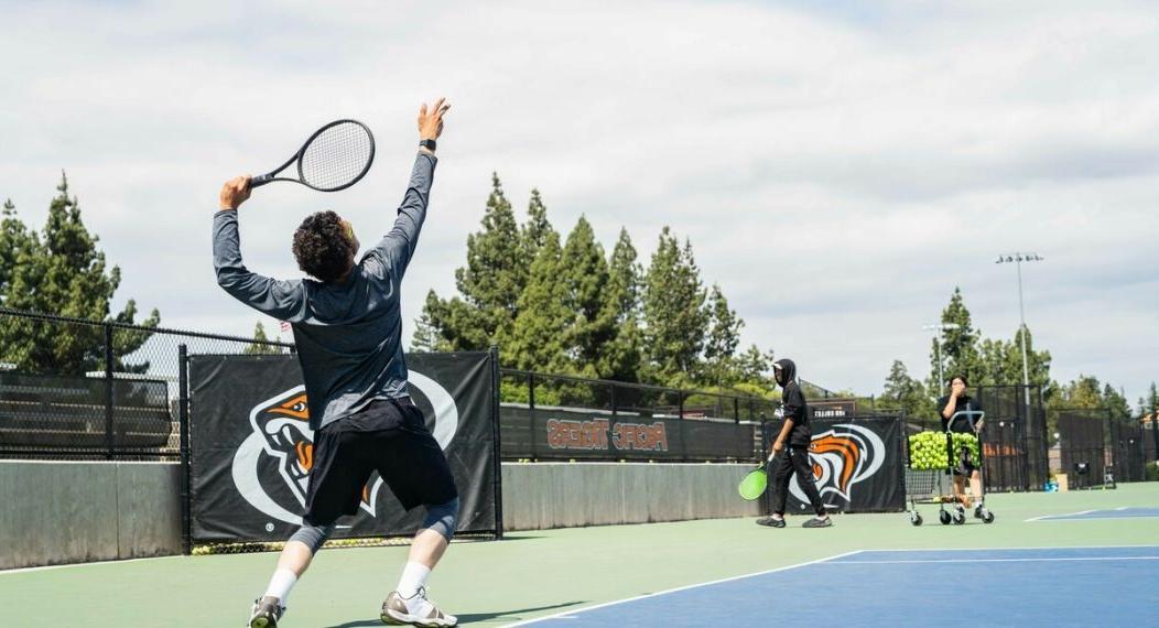 Tennis student serving