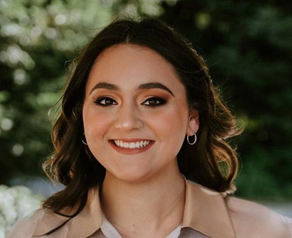 A portrait of a woman wearing a button down shirt 